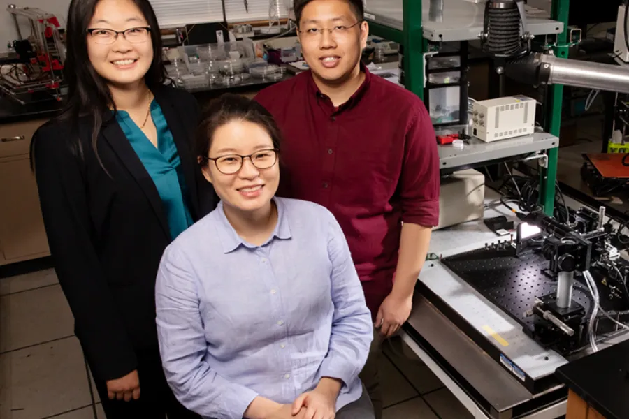 Professor Ying Diao, left, postdoctoral researcher Kyung Sun Park, seated, and graduate student Justin Kwok have found that twisted polymers can be flattened via the printing process to make them better at conducting electricity. 