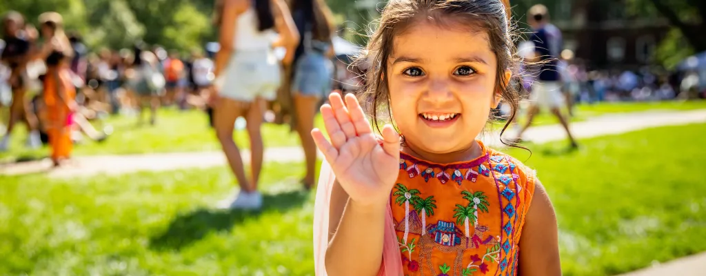 small girl waiving