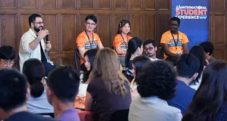 Four speakers speak during the Aug. 18 Graduate Connections Meet-up inside the University YMCA. 