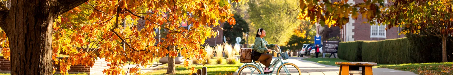 woman riding bike on campus